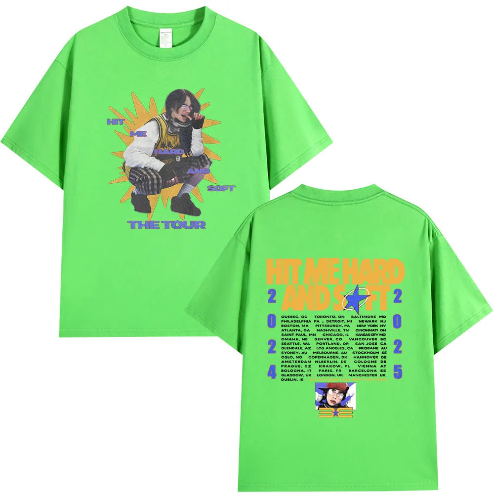 A bright green t-shirt featuring a graphic design related to the Hit Me Hard and Soft Tour.