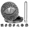 A silver steampunk dragon eye watch case with a lid and seven small dice.