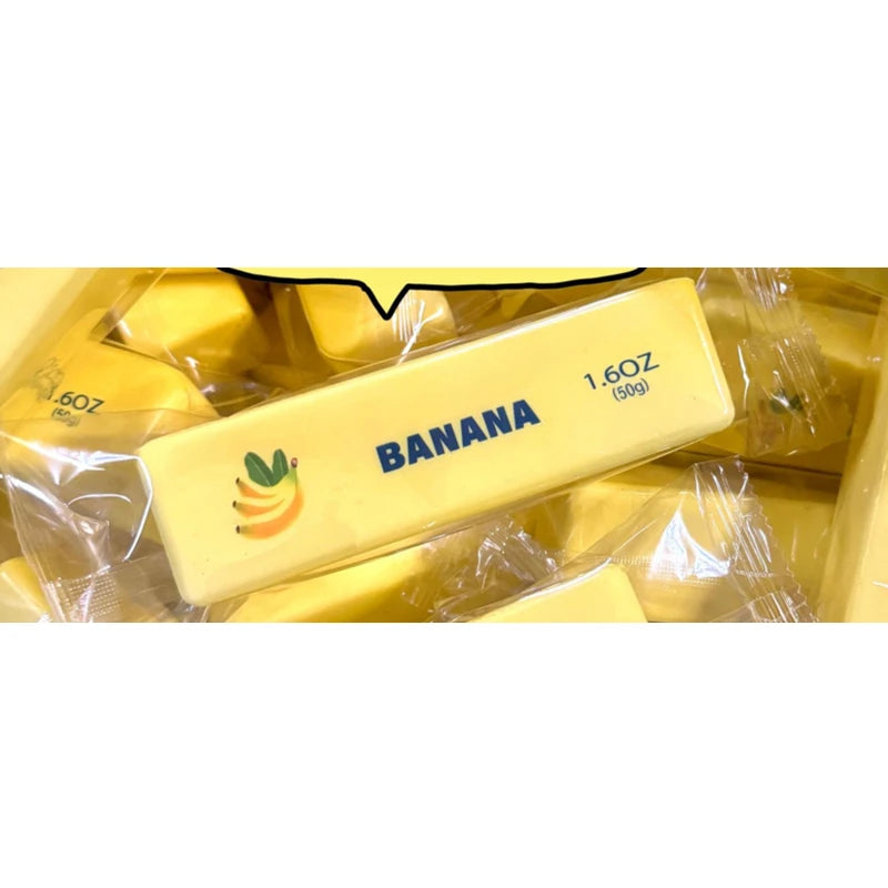 A yellow squishy toy shaped like a banana is visible in clear plastic packaging.