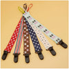 A set of four soft pacifier clips with double-sided prints in various patterns and colors