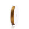 A spool of gold-colored stainless steel tiger tail beading wire for jewelry making.