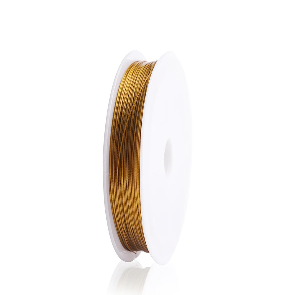 A spool of gold-colored stainless steel tiger tail beading wire for jewelry making.