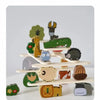 A stack of wooden animal blocks featuring various woodland creatures like a giraffe, hedgehog, and owl.