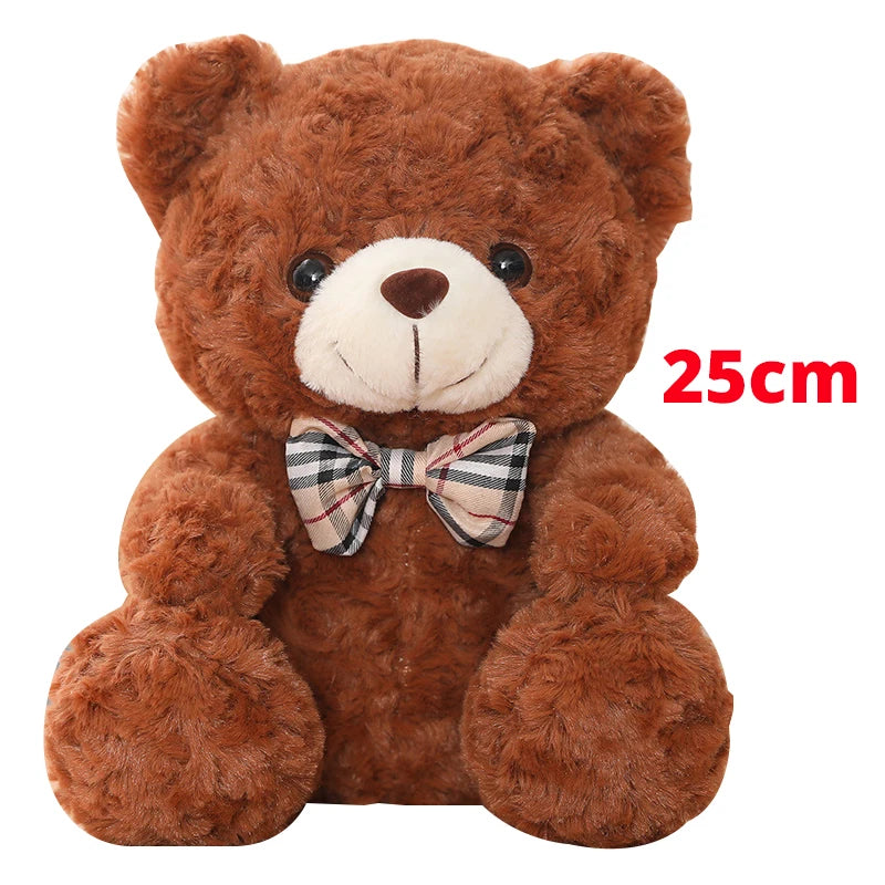 A brown teddy bear plush pillow with a plaid bow, measuring 25cm.