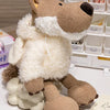 A soft brown plush toy resembling a wolf in sheep's clothing, featuring light cream fur and white accents.