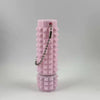 A pink, textured cylindrical fidget toy with a keychain attached.