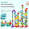A colorful set of plastic track designs for a marble run including a spiral staircase and T-shaped bifurcation
