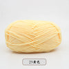 A ball of light yellow pre-dyed milk cotton yarn for knitting and crochet.