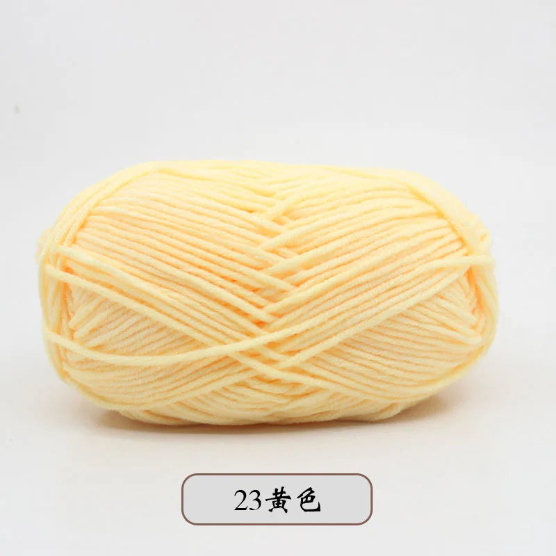 A ball of light yellow pre-dyed milk cotton yarn for knitting and crochet.