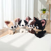 A collection of five Chihuahua plush dolls with tongues out, featuring various colors and markings, displayed on a white surf