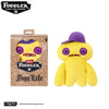 A yellow Fuggler Tooth Monsters plush toy with purple accents, displayed next to its packaging.