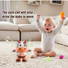 A baby is laughing while interacting with an orange toy and a plush cow toy on a white rug.