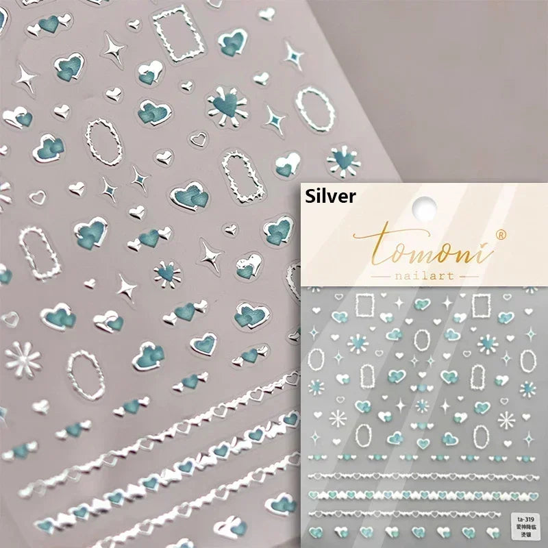 Silver nail art stickers featuring various shapes like hearts, stars, and ovals on a light gray background