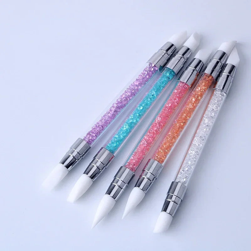 A set of dual-ended silicone nail art dotting pens with crystal colored handles and white tips.