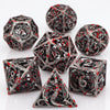 A set of black metal dice shaped like a blood dragon for tabletop role-playing games