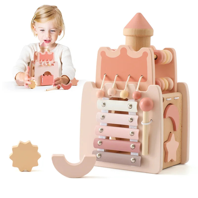 A young child is playing with a wooden rocket stacking toy that functions as a shape sorter.