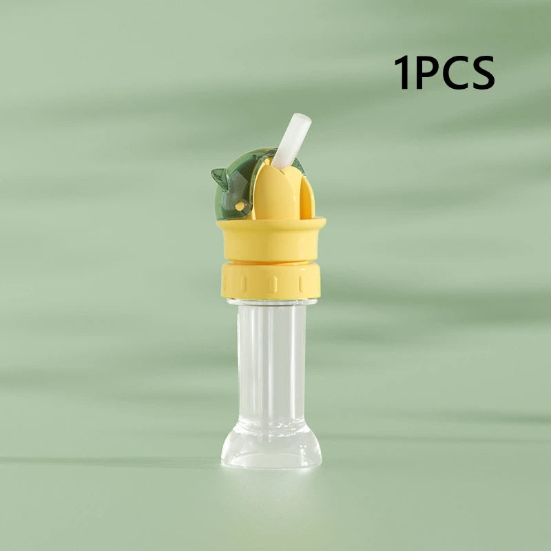 A clear plastic straw and bottle cap converter with a green and yellow design for children.