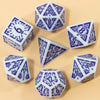 A set of seven fantasy carved polyhedral dice in white and purple on a light background.