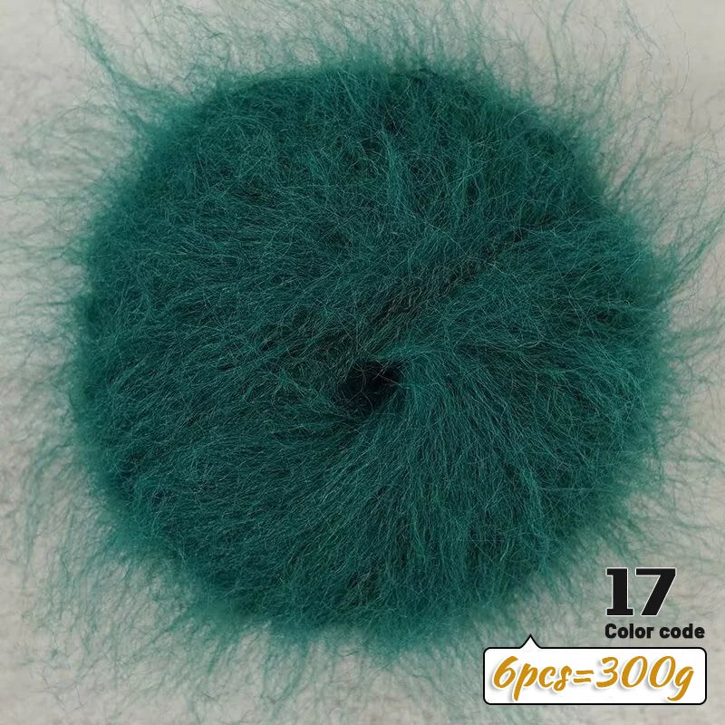 A circular swatch of dark teal long-haired alpaca blend yarn used for knitting.