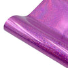 A close-up of a purple glitter holographic heat transfer vinyl sheet rolled up.