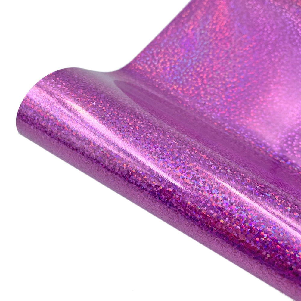 A close-up of a purple glitter holographic heat transfer vinyl sheet rolled up.