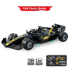 A black 1:64 scale RC drift car model with yellow accents and a transparent battery pack.