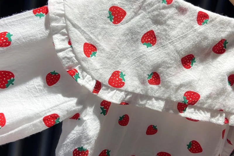 White long-sleeve shirt for a baby girl with a red strawberry print