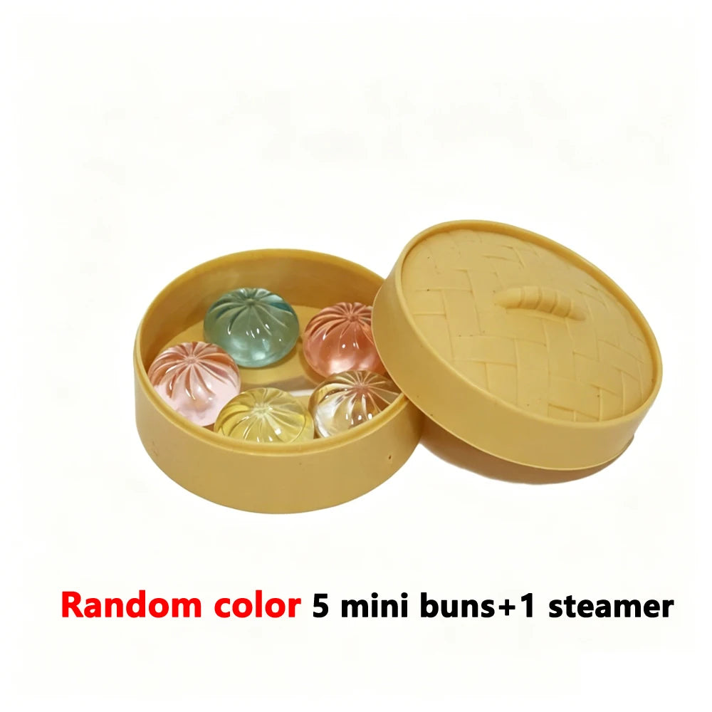 A yellow container holds five colored mini buns and one steamer basket.