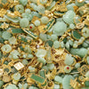 A close-up of green imitation jade charms and beads mixed with gold-colored jewelry findings.