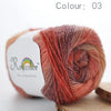 A ball of hand-dyed merino wool yarn in a reddish-orange color, labeled as Colour 03.