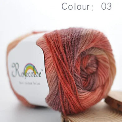 A ball of hand-dyed merino wool yarn in a reddish-orange color, labeled as Colour 03.