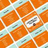 A close-up view of a Spanish word guessing board game featuring cards with various vocabulary words and instructions.
