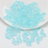 A pile of light blue butterfly glass beads for jewelry making
