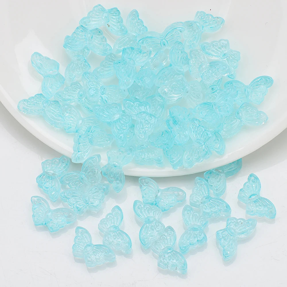 A pile of light blue butterfly glass beads for jewelry making