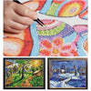 A hand is painting a colorful landscape diamond painting on a canvas.