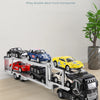 A white alloy double-deck truck transporter carrying several diecast model cars.