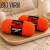 Two orange Knitnex super soft acrylic yarns are displayed on a wooden board.