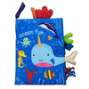 A blue sensory cloth book featuring an ocean theme with a whale, fish, and sea creatures.