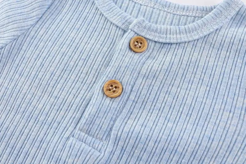Light blue knitted cotton baby bodysuit with a collar and wooden buttons