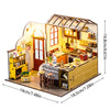 A wooden mini seaside villa dollhouse kit featuring furniture and decorative elements.