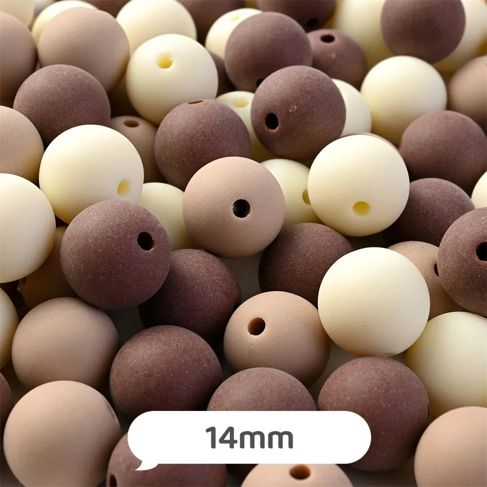A close-up view of various pastel bear-shaped acrylic craft beads in shades of brown and cream.