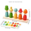 A set of wooden puppet hats in various colors stacked on a light wooden board for face matching