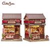 A detailed 3D wooden book nook kit featuring a traditional Japanese-style shop facade with LED lighting.