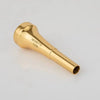 A gold-plated trumpet mouthpiece with a tapered, conical shape.