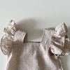 A light beige gingham ruffle top and shorts set for a baby girl summer outfit.