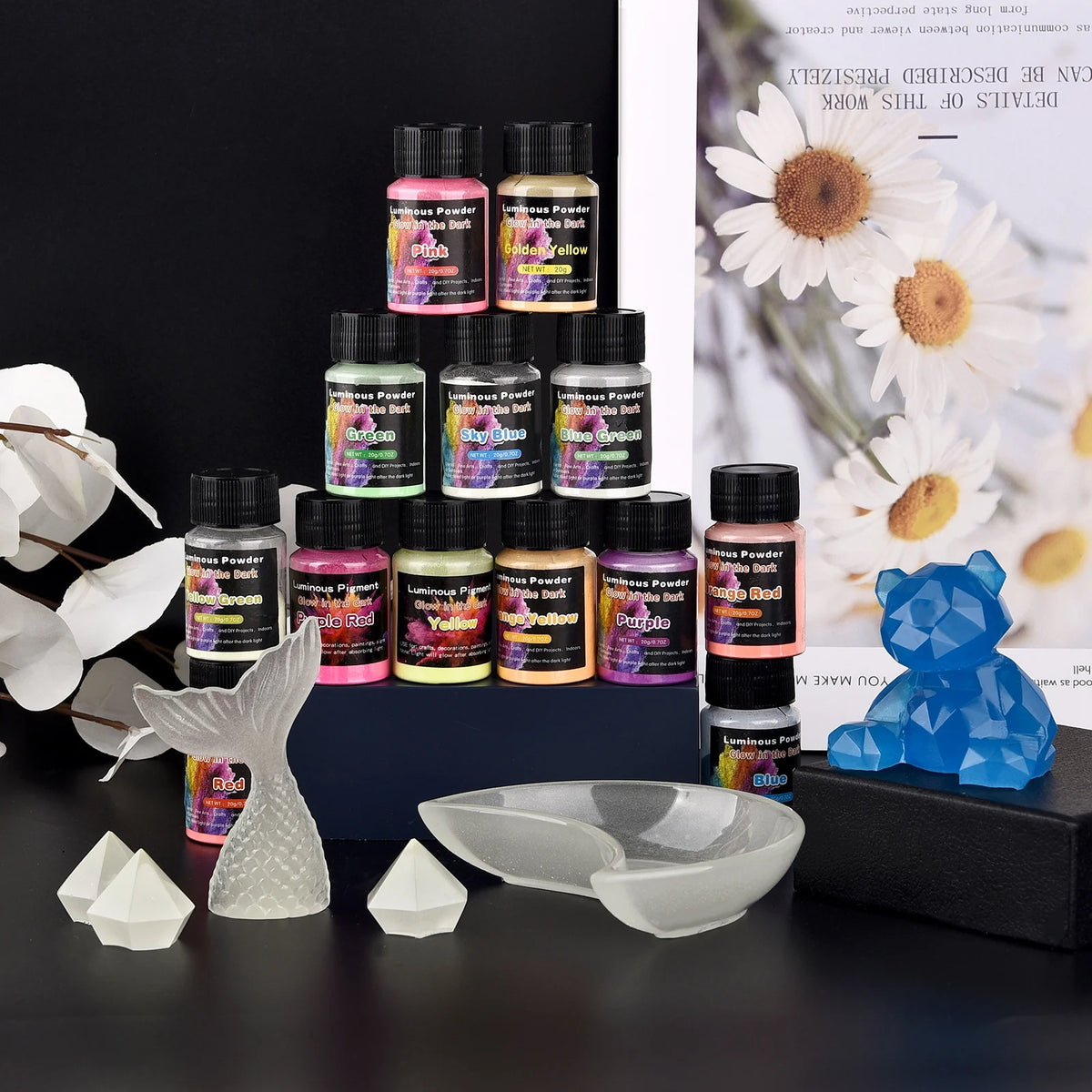 A collection of Luminous Glow-in-the-Dark Pigment Powder in various colors displayed on a dark surface.