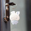 A white fluffy bunny plush toy with blue accents and a checkered bow is attached to a metal keychain.