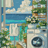 A diamond painting kit featuring a seaside scene with lush greenery, flowers, and laundry hanging by a window.