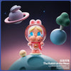 A collectible figurine of a rabbit character with pink and white features floating above a blue spherical base against a dark