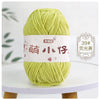 A ball of light green chenille yarn labeled with Chinese characters for knitting and crochet.